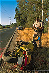 Picture: CHP Highway Patrol police officer writing up an accident report after a motorcyle crash on two lane rural country road in Napa Valley, California