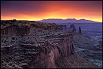 Photo: Stormy sunrise over the LaSal Mtns. and red rock cliffs from Mesa Arch, Island in the Sky, Canyonlands NP, Utah