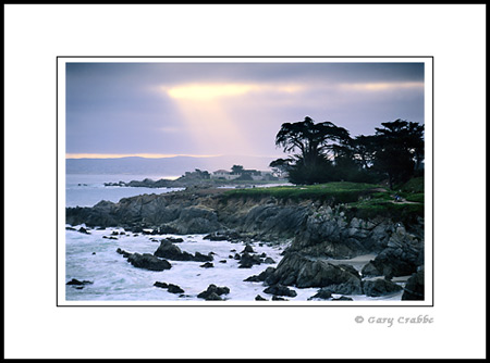 Sunbeam sun rays through coastal fog over Monterey, Monterey Coast, California