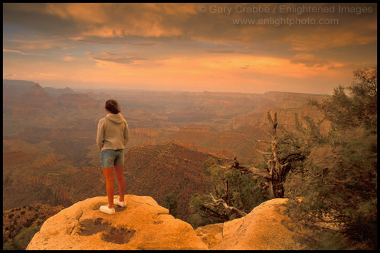 Picture: Female tourist overlooking the Grand Canyon at sunset, Grand Canyon National Park, Arizona