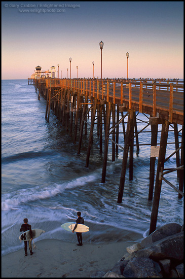 Picture: Surfers checking out the waves, next to the Oceanside Pier, California
