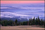 Photo: Morning light and misty clouds over trees, forest, and hills, Crater Lake National Park, Oregon