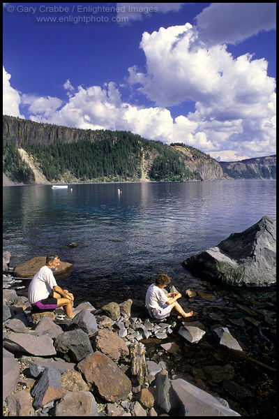 Photo: Tourists relaxing on the rocky shoreline at Cleetwood Cove, Crater Lake National Park, Oregon