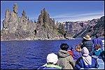 Photo: Tourists on boat tour going around The Phantom Ship on Crater Lake, Crater Lake National Park, Oregon