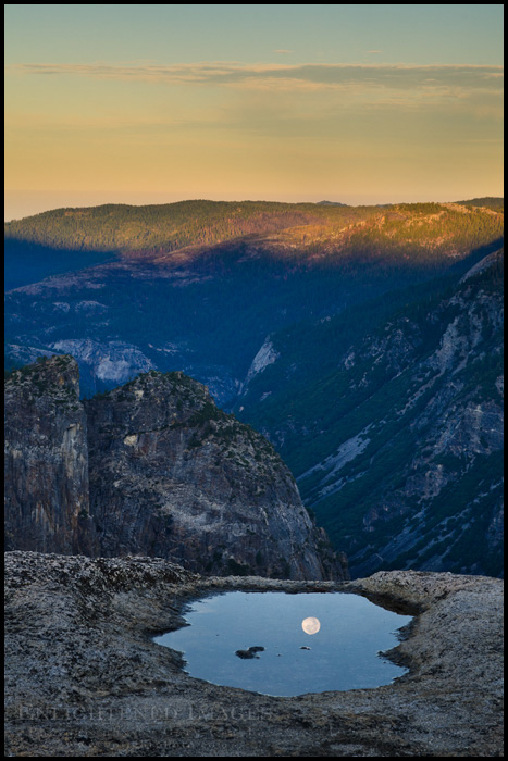 Picture: Full moon reflected in puddle at sunrise, from Taft Point, above Yosemite Valley, Yosemite National Park, California