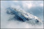 Picture: Fall storm clouds shroud the snow covered shoulder of Half Dome, Yosemite Valley, Yosemite National Park, California