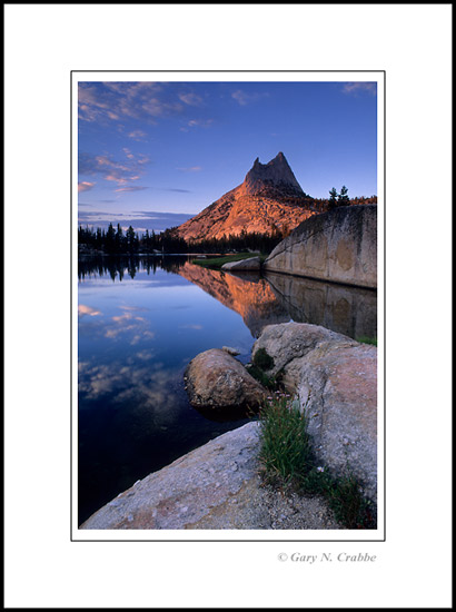 Photo: Sunset light on Cathedral Peak reflected in Upper Cathedral Lake, Yosemite National Park, California