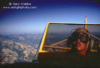 Open cockpit flying in a twin-seat Bi-plane WWII trainer aircraft