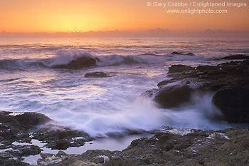 Waves crash on coastal rocks at sunset, Point Lobos State Reserve, near Carmel, California