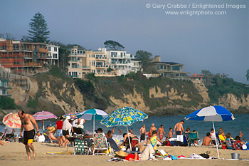 Crowded sand beach and sunbathers and umbrella, Corona del Mar, Newport Beach, California