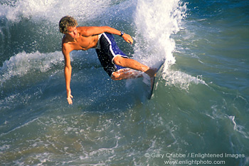 Surfer surfing on breaking wave using a skimboard, near Balboa Pier, Balboa Island, Newport Beach, California