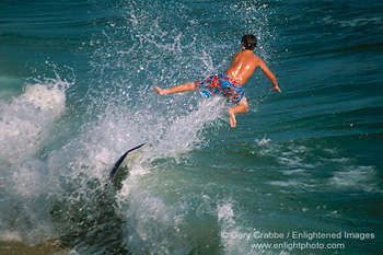 Boogie board surfer flying through air over ocean wave, Balboa Island, Newport Beach, Southern California Coast