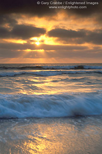 Sunset light and fog over ocean waves breaking at Torrey Pines State Beach, near Del Mar, San Diego County Coast, California