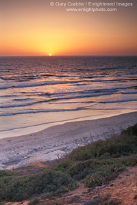 Sunset over beach and Pacific Ocean at Carlsbad, San Diego County Coast, California