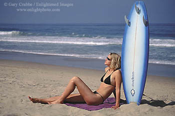 Woman sunbathing on the beach in Southern California