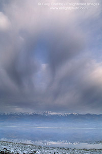 Storm clouds building over the Panamint Mountains and water filled desert basin in spring, near Badwater, Death Valley National Park, California; Stock Photo image picture photo Phograph art decor print wall mural gallery