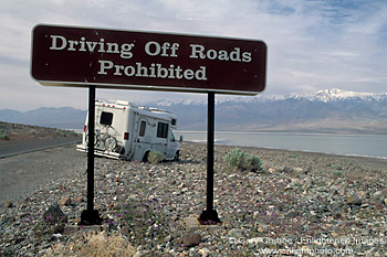 Tourists drive RV camper off road and get stuck in rocks next to warning sign, near Badwater, Death Valley National Park, California; Stock Photo image picture photo Phograph art decor print wall mural gallery