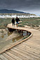 Tourist Couple on boardwalk pathway at Salt Creek Natural Area, Death Valley National Park, California