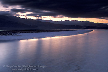 Evening light and storm clouds at sunset over water in flooded Middle Basin, Death Valley National Park, California; Stock Photo image picture photo Phograph art decor print wall mural gallery