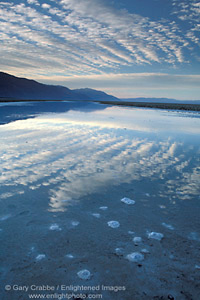 Morning clouds reflected in water flooded basin in spring, Death Valley National Park, California; Stock Photo image picture photo Phograph art decor print wall mural gallery