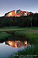 Sunrise light on Mount Lassen volcano reflected in water in Upper Meadow, Lassen Volcanic National Park, California