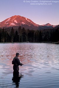 Lone fisherman fishing in Manzanita Lake at sunset below Mount Lassen, Lassen Volcanic National Park, California; Stock Photo photography picture image photograph fine art decor print wall mural gallery