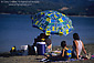 Family on Beach with shade umbrella, Lake Mendocino, Mendocino County, California
