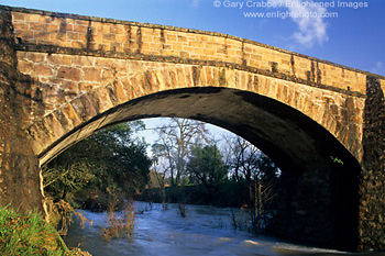 Sunset light on old stone bridge over the Napa River, near St. Helena, Napa Valley Wine Region, California