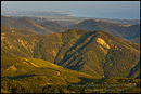 Photo: Sunset light on rolling green coastal hills in Spring above the Pacific Ocean, near Santa Barbara, California