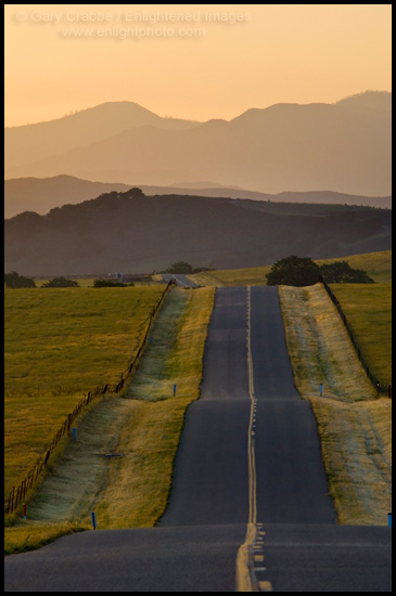 Photo: Golden sunrise light over long straight two lane country road and rolling hills in Spring, Santa Ynez Valley, California