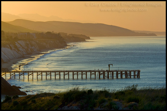 Photo: Golden sunrise light over coastal hills, pier, and beach at Gaviota Beach State Park, near Santa Barbara, California