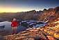 Hiker at sunset on mountain pass above the Nine Lakes Basin, Eastern Sierra, California