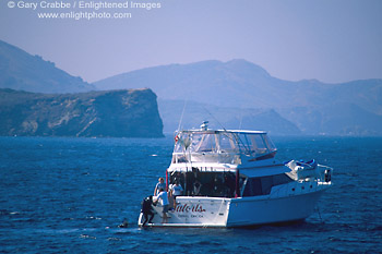 Picture: Scuba divers and dive boat at anchor off Two Harbors, Catalina Island, California