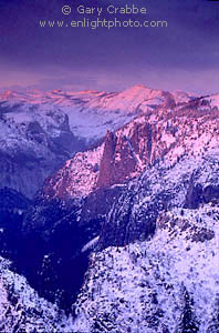 Winter sunset on snow covered peaks of the High Sierra over Yosemite Valley from Dewey Point, Yosemite National Park, California