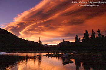 Lenticular cloud at sunset over alpine pond near Tioga Pass, Yosemite National Park, California