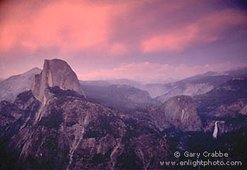 Alpenglow at sunset on storm clouds over Half Dome and Little Yosemite Valley, from Glacier Point, Yosemite National Park, California