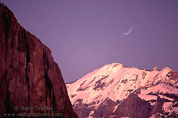 Crescent moon at twilight over snow-capped Clouds Rest, Yosemite National Park, California