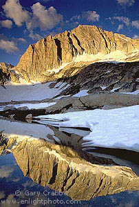 Sunrise light on North Peak mountain reflected in alpine lake, Hoover Wilderness, near Yosemite National Park, California