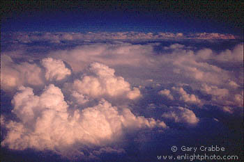 Sunset light on Cumulostratus storm clouds as seen from 30,000 feet