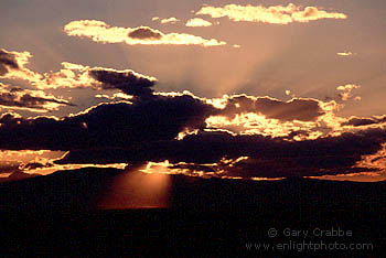 Sunset and god-beams through storm clouds over southern Colorado