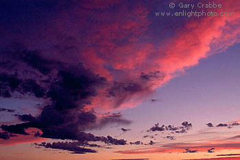 Sunset light turns altocumulus clouds bright red, California