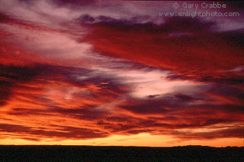 Bright red altostratus clouds at sunset over the Arizona desert