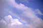 Rainbow and blue sky beneath clearing storm clouds