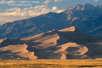 Sunset light on sand dunes, Great Sand Dunes National Monument, below the Sange de Christos mountain range, Colorado