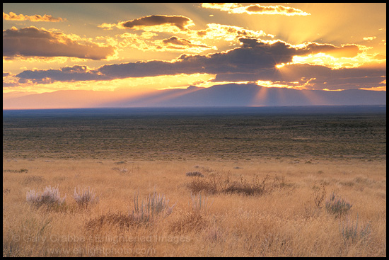 Picture: Golden sunbeams through clouds at sunset over the High Desert of Southern Colorado