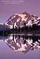 Evening light on Mount Shuksan reflected in an alpine lake, in the Mount Baker National Recreation Area, Washington