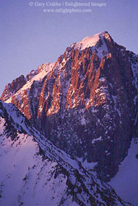 Alpenglow at sunrise as first light in winter on the summit of Mount Morrison, near Mammoth Lakes, Eastern Sierra, California