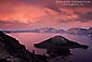 Alpenglow on storm clouds create a red sky at sunset over Crater Lake, Crater Lake National Park, Oregon