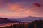 Red sky at sunset over Mount Thielsen and grass covered mountain valley, from rim of Crater Lake, Crater Lake National Park, Oregon