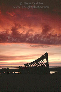 Stormy sunset on clouds over the shipwrecked remains of the Peter Iredale, Fort Stevens State Park, near Astoria, Northern Oregon coast